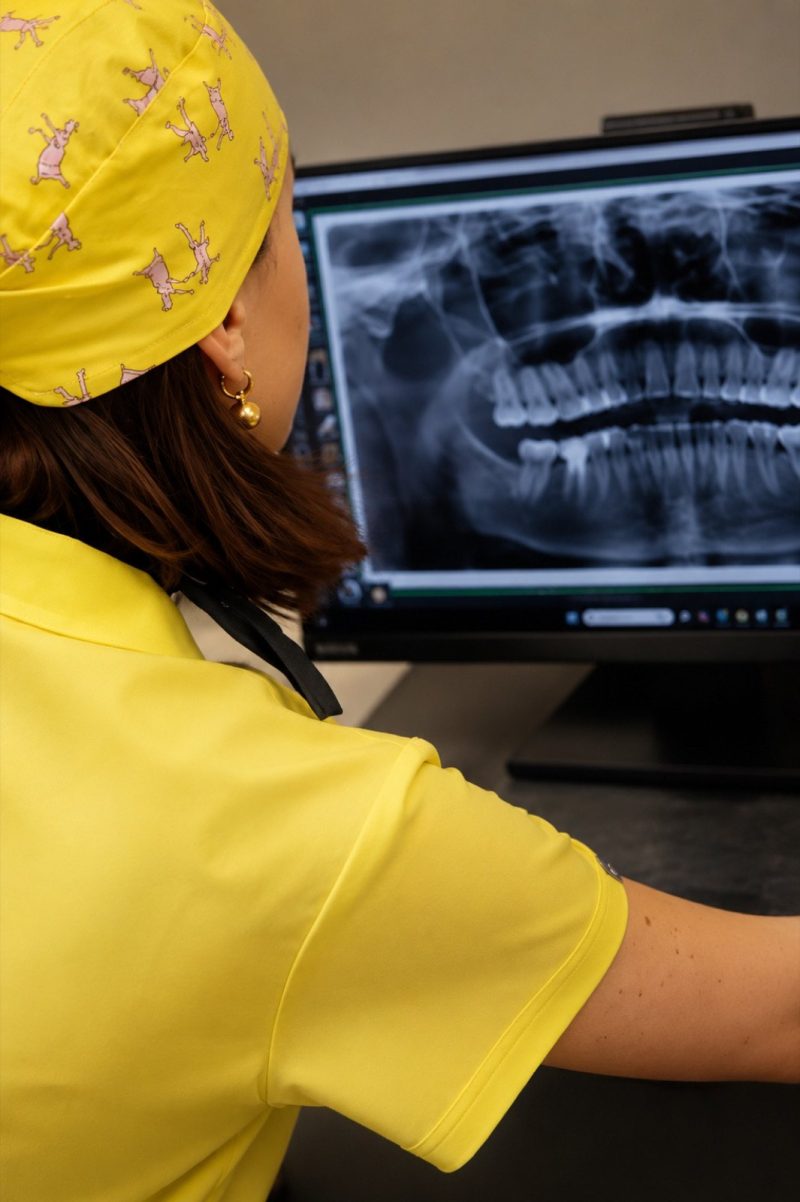 Dentist reviewing a panoramic X-ray at Genesis Dental Centre